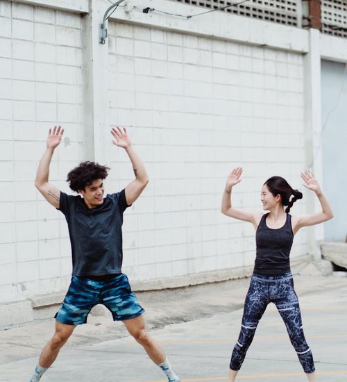 Man smiling and looking energetic after a workout session outdoors.